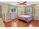 Bright bedroom with hardwood floors, a dresser and ceiling fan at 2503 Bispham Rd, Sarasota, FL 34231