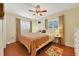 Comfortable bedroom with hardwood floors, ceiling fan, and ample natural light at 2503 Bispham Rd, Sarasota, FL 34231