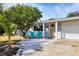 House exterior featuring a light blue facade, two teal chairs, and a carport at 2503 Bispham Rd, Sarasota, FL 34231