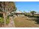 Fenced backyard with mature trees and a walkway leading to the house at 2519 17Th W Ave, Bradenton, FL 34205