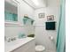 Small bathroom with white vanity, beadboard, and teal accents at 2519 17Th W Ave, Bradenton, FL 34205