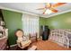 Bedroom with green walls, antique chair, and safe at 2519 17Th W Ave, Bradenton, FL 34205