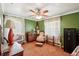 Cozy bedroom with green walls, antique chair, and safe at 2519 17Th W Ave, Bradenton, FL 34205