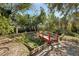 Landscaped garden with a charming red bridge and pond feature at 2519 17Th W Ave, Bradenton, FL 34205