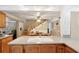 Kitchen with wooden cabinets and a view of the staircase at 2519 17Th W Ave, Bradenton, FL 34205