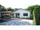 Contemporary home with a spacious paved driveway and outdoor seating area at 2606 19Th St, Sarasota, FL 34234