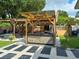 Covered outdoor kitchen area with grill and seating at 2606 19Th St, Sarasota, FL 34234