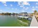 Private boat dock with covered lift in a waterfront community at 2762 W Vina Del Mar Blvd, St Pete Beach, FL 33706