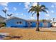 Ranch style home with a light blue exterior, palm trees, and gravel landscaping at 2762 W Vina Del Mar Blvd, St Pete Beach, FL 33706