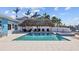 Refreshing backyard pool with a tiki hut and spacious patio at 2762 W Vina Del Mar Blvd, St Pete Beach, FL 33706