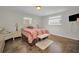 Cozy bedroom featuring a tiled floor and a decorative bench at 3055 Holiday Lake Dr, Holiday, FL 34691