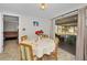 Cozy dining area with table and chairs, opening to a screened porch at 3055 Holiday Lake Dr, Holiday, FL 34691