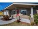 Covered porch with red door and brick exterior at 3055 Holiday Lake Dr, Holiday, FL 34691