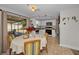 Kitchen features white cabinets, a microwave, and a view to the dining area at 3055 Holiday Lake Dr, Holiday, FL 34691