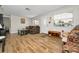 Bright living room featuring wood-look floors and ample natural light at 3055 Holiday Lake Dr, Holiday, FL 34691