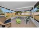 Relaxing screened porch with wicker furniture and a green table at 3055 Holiday Lake Dr, Holiday, FL 34691