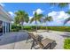 Relaxing backyard patio with lounge chairs and ocean views at 325 Casey Key Rd, Nokomis, FL 34275