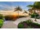 Beachfront backyard with sunset views and tropical plants at 325 Casey Key Rd, Nokomis, FL 34275