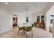 Bright dining area with white table and green chairs, offering a view into a bedroom at 325 Casey Key Rd, Nokomis, FL 34275