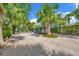 Gated driveway with tropical landscaping and ample parking at 325 Casey Key Rd, Nokomis, FL 34275