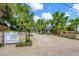 Private driveway with lush landscaping and gated entry at 325 Casey Key Rd, Nokomis, FL 34275