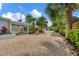 Landscaped front yard with gravel pathway and tropical plants at 325 Casey Key Rd, Nokomis, FL 34275