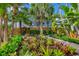 Mature tropical plants and bromeliads fill the garden at 325 Casey Key Rd, Nokomis, FL 34275