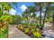 Lush tropical garden with a gravel pathway at 325 Casey Key Rd, Nokomis, FL 34275