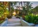 Pathway leading to the home through a beautifully landscaped garden at 325 Casey Key Rd, Nokomis, FL 34275