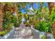 Stone walkway leads through lush tropical landscaping at 325 Casey Key Rd, Nokomis, FL 34275