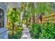 A walkway winds through a lush, tropical garden at 325 Casey Key Rd, Nokomis, FL 34275