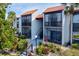 Inviting condo building with lush landscaping and a walkway at 3275 Beneva Rd # 104, Sarasota, FL 34232