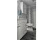 Bathroom with updated vanity, shower, and gray wood-look tile floors at 3401 Rochelle Ct # 131, Clearwater, FL 33761