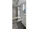 Clean bathroom offers gray floors, toilet, and tub with shower at 3401 Rochelle Ct # 131, Clearwater, FL 33761