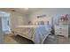 Bedroom with queen bed, built-in shelving, and access to bathroom at 3401 Rochelle Ct # 131, Clearwater, FL 33761