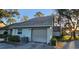 Attached garage with gray door and AC unit at 3401 Rochelle Ct # 131, Clearwater, FL 33761