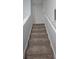 Carpeted staircase with white railings, leading upwards, creating a transition between floors at 3401 Rochelle Ct # 131, Clearwater, FL 33761