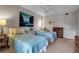 Guest bedroom with twin beds, dresser, and large artwork at 3460 Wild Oak Bay Blvd # 145, Bradenton, FL 34210