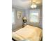 Guest bedroom with yellow bedding and a ceiling fan at 4019 Worcester Rd, Sarasota, FL 34231