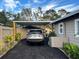 Gray SUV parked under carport with room for another vehicle at 4019 Worcester Rd, Sarasota, FL 34231