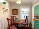 Small dining area with red chairs and a round wooden table at 4019 Worcester Rd, Sarasota, FL 34231