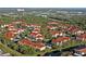 Aerial view of community with red tile roofs and pond at 4122 Central Sarasota Pkwy # 1925, Sarasota, FL 34238