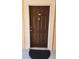 Dark brown front door with a doormat at 4122 Central Sarasota Pkwy # 1925, Sarasota, FL 34238