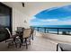 Relaxing balcony with ocean views, featuring a dining table, chairs, and a serene atmosphere at 415 L Ambiance Dr # C404, Longboat Key, FL 34228