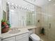 Bright bathroom with a seamless glass shower and a large mirror with Hollywood-style lighting at 415 L Ambiance Dr # C404, Longboat Key, FL 34228