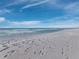 View of the beach showing footprints in the sand with a light wave action on the water's edge at 415 L Ambiance Dr # C404, Longboat Key, FL 34228