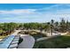 Scenic entrance with a landscaped driveway and lush greenery at 415 L Ambiance Dr # C404, Longboat Key, FL 34228