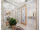 Bright foyer with decorative door, stone accents, mirror and a glimpse into the spacious living area at 415 L Ambiance Dr # C404, Longboat Key, FL 34228