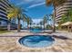 Circular jacuzzi nestled between palms in a courtyard with views of neighboring high-rise residences at 415 L Ambiance Dr # C404, Longboat Key, FL 34228