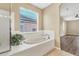 Oval soaking tub and window in a bright bathroom at 4360 85Th Avenue E Cir, Parrish, FL 34219